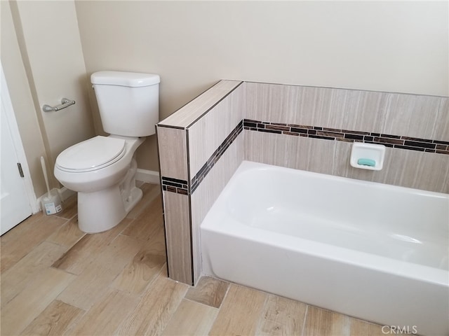 bathroom featuring a bathing tub and toilet