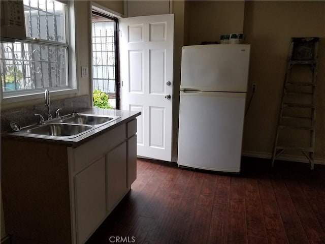 kitchen with dark hardwood / wood-style floors, white fridge, and sink