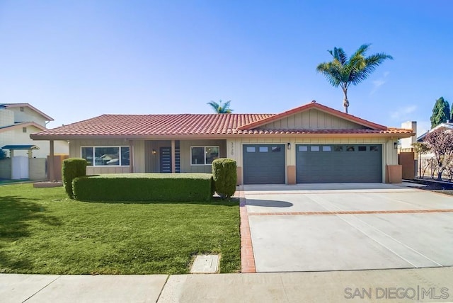 ranch-style home with a garage and a front lawn