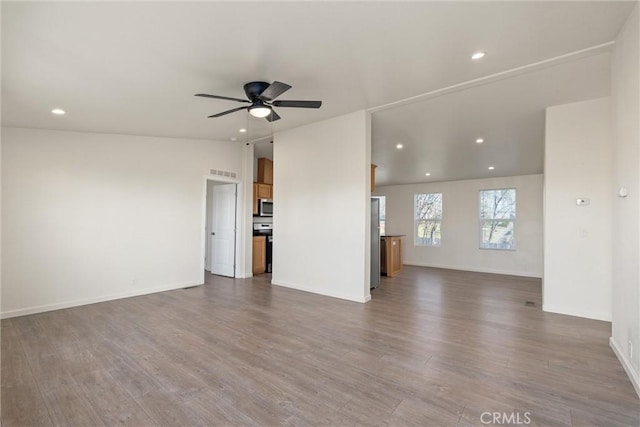 unfurnished living room with ceiling fan and wood-type flooring