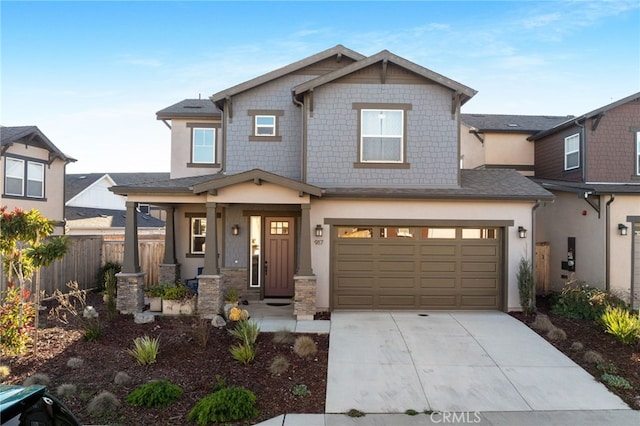 craftsman-style home featuring covered porch and a garage