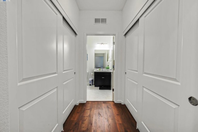 hall with dark wood-type flooring