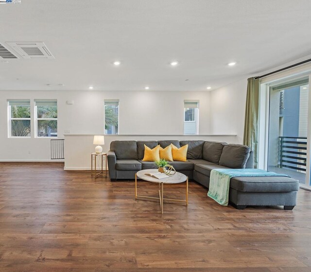 living room with radiator heating unit and dark hardwood / wood-style flooring