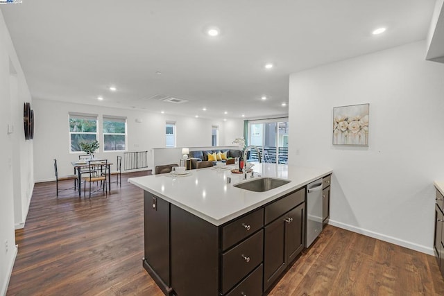 kitchen featuring dishwasher, sink, dark hardwood / wood-style flooring, and dark brown cabinetry