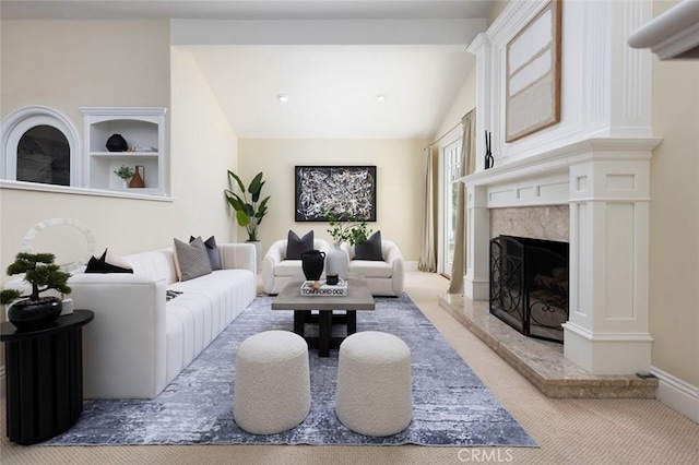 carpeted living room with a premium fireplace and lofted ceiling