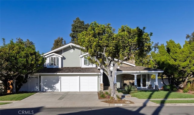 view of front of property featuring a front yard and a garage