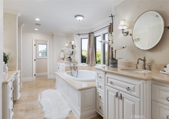 bathroom featuring vanity, a bathing tub, and ornamental molding