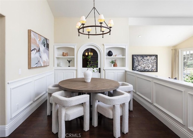 dining space featuring a chandelier, dark hardwood / wood-style flooring, and built in shelves