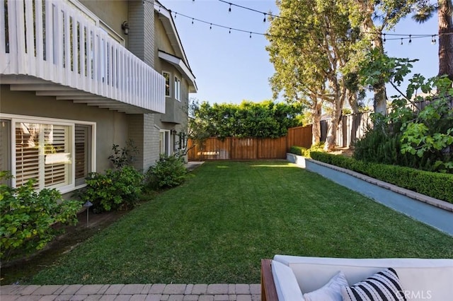 view of yard with a balcony