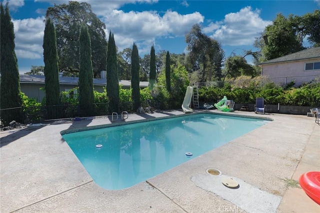 view of swimming pool featuring a patio area and a water slide