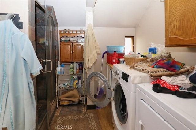 washroom featuring cabinets, washer and clothes dryer, and dark hardwood / wood-style floors