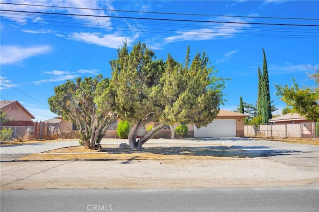 obstructed view of property with a garage