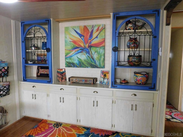 bar featuring white cabinets