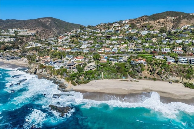 aerial view featuring a water and mountain view and a view of the beach