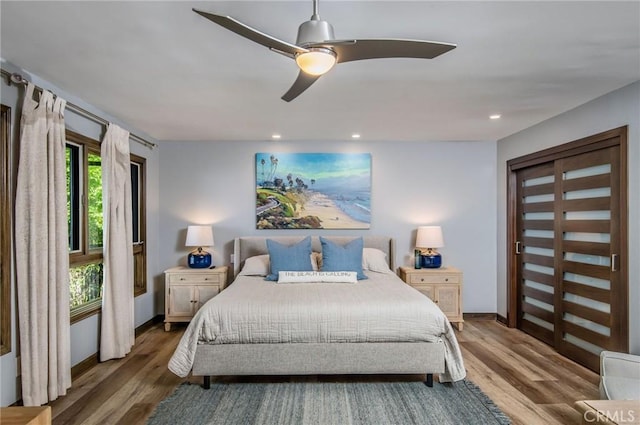 bedroom with ceiling fan and dark hardwood / wood-style flooring