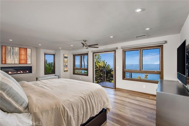 bedroom with ceiling fan, access to exterior, and light wood-type flooring