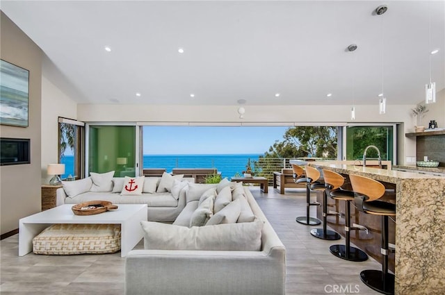 living room featuring recessed lighting and a water view