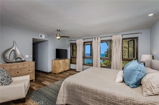 bedroom featuring ceiling fan and dark wood-type flooring