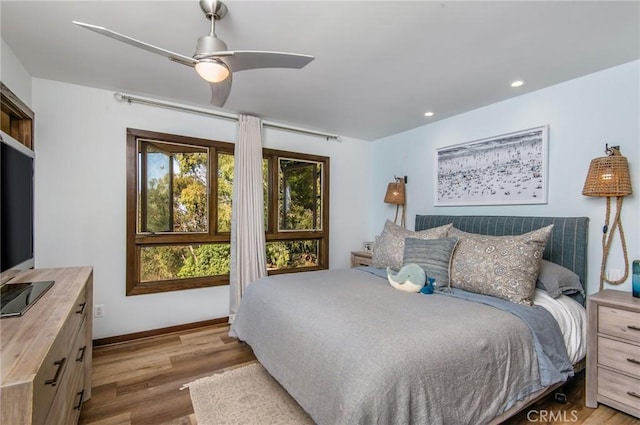 bedroom featuring ceiling fan and hardwood / wood-style flooring