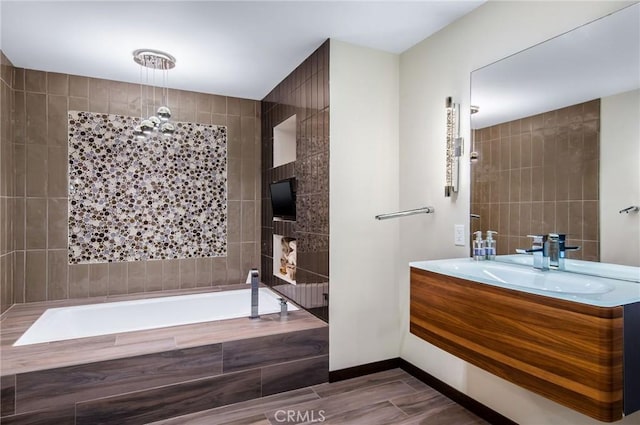 bathroom with tiled shower / bath combo and vanity