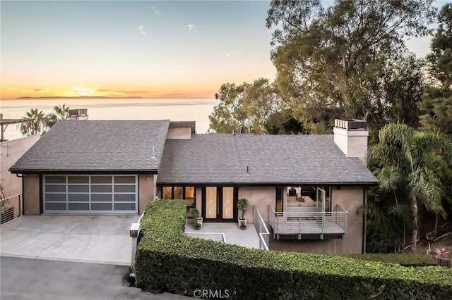 view of front of house featuring a water view and a garage