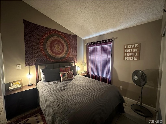 bedroom with a textured ceiling and vaulted ceiling