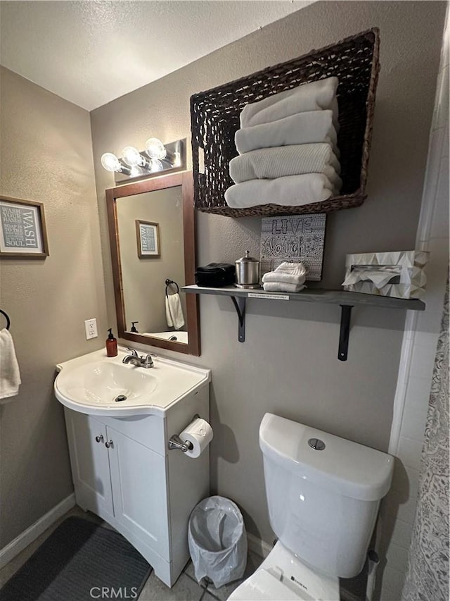 bathroom featuring toilet and vanity