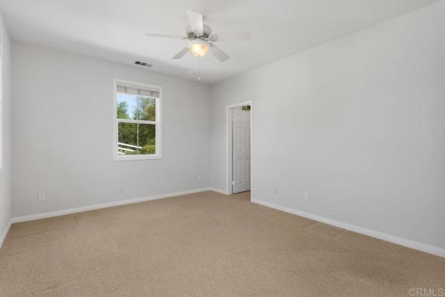 unfurnished room featuring ceiling fan and light colored carpet