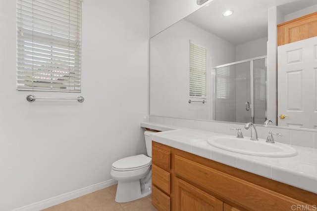 bathroom with toilet, vanity, tile patterned flooring, and a shower with door