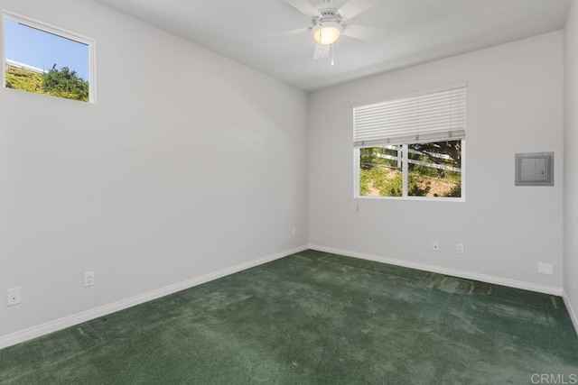 carpeted spare room featuring ceiling fan