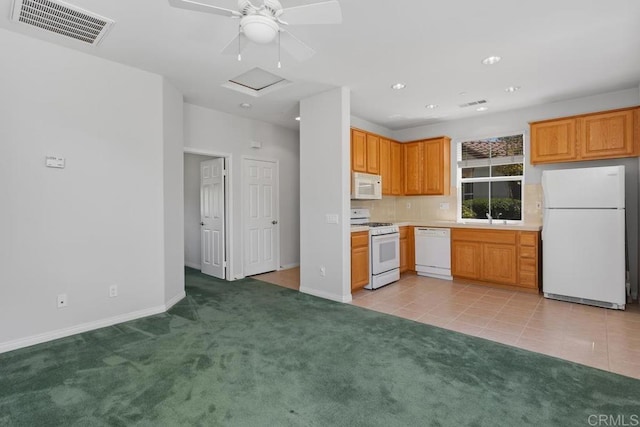 kitchen featuring white appliances, tasteful backsplash, sink, ceiling fan, and light colored carpet