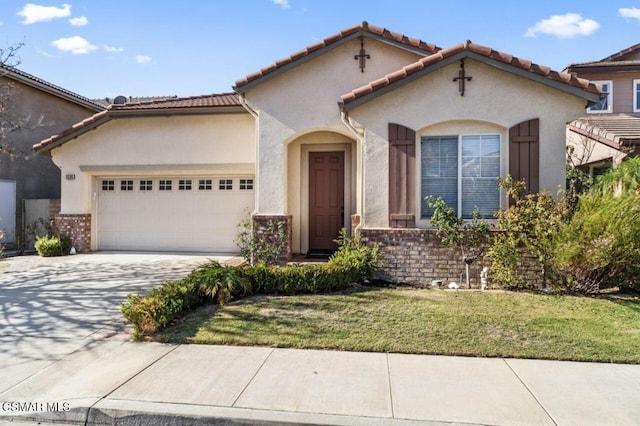 mediterranean / spanish house with a front yard and a garage