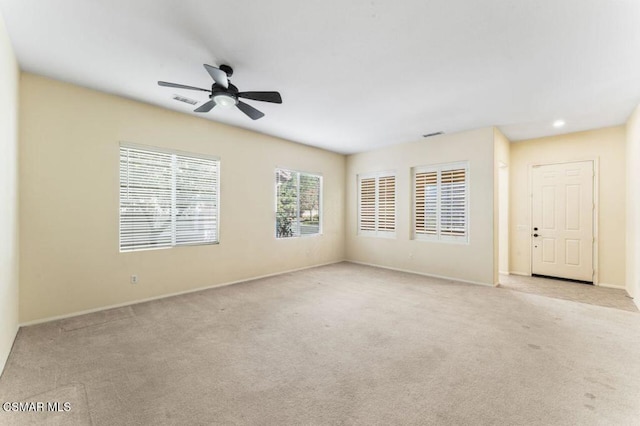 unfurnished room featuring light carpet and ceiling fan