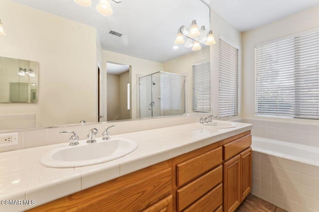 bathroom featuring vanity, tile patterned flooring, and plus walk in shower