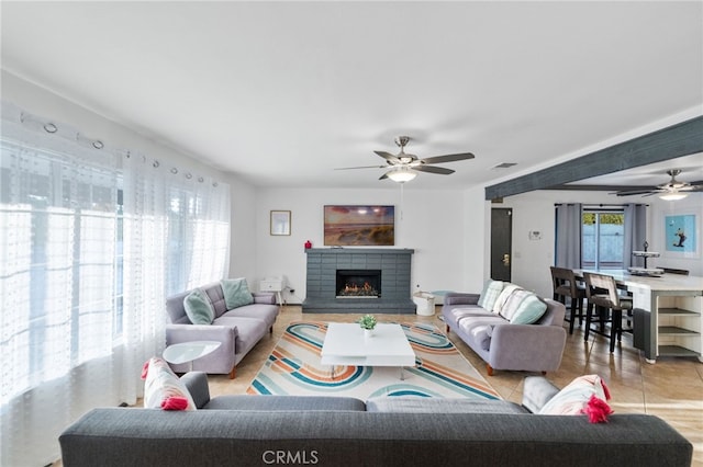 tiled living room with ceiling fan