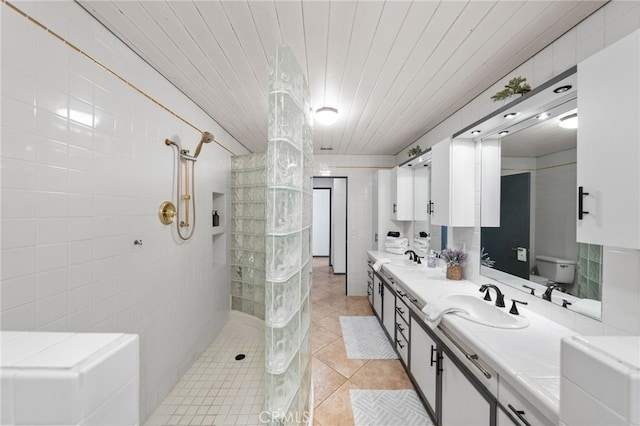 bathroom featuring tile patterned floors, vanity, tile walls, walk in shower, and wooden ceiling