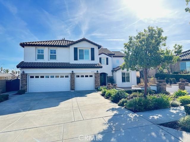 mediterranean / spanish home with a garage