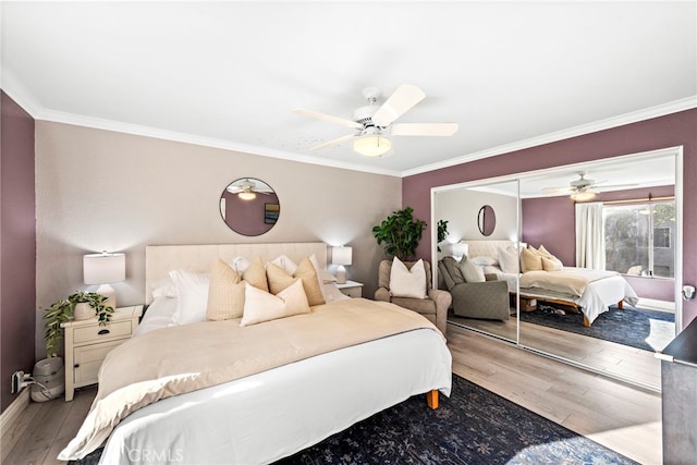 bedroom featuring ceiling fan, a closet, crown molding, and light wood-type flooring