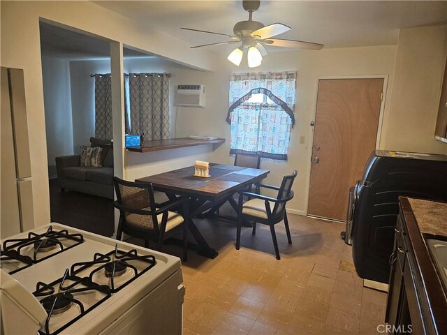 dining space featuring ceiling fan and a wall mounted air conditioner