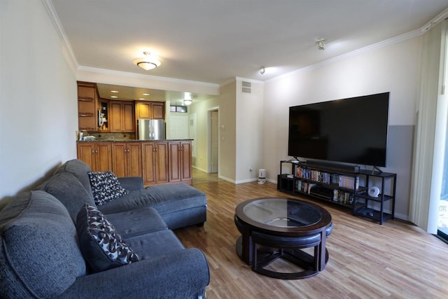 living room with light hardwood / wood-style flooring and ornamental molding