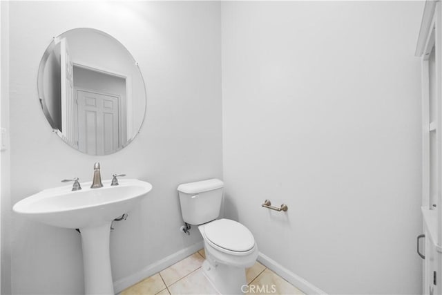 bathroom featuring sink, toilet, and tile patterned flooring