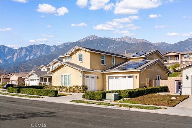 view of front of house with a mountain view and solar panels