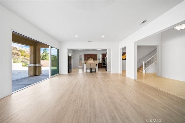 unfurnished living room featuring light wood-type flooring