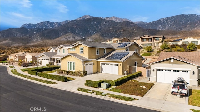 view of front of house featuring a mountain view and solar panels