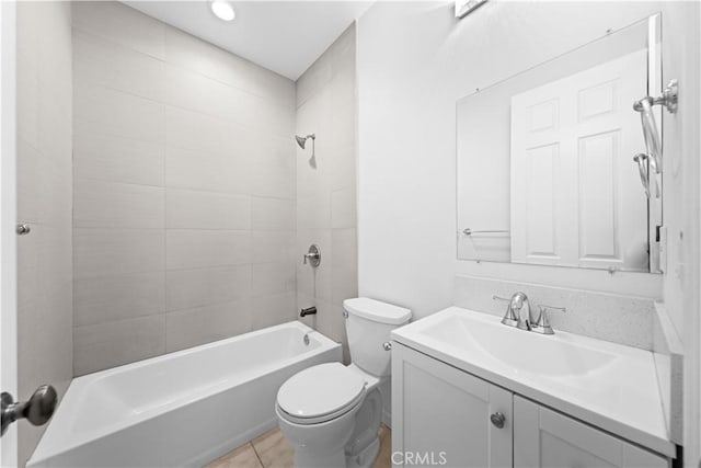 full bathroom with toilet, vanity, tiled shower / bath, and tile patterned flooring