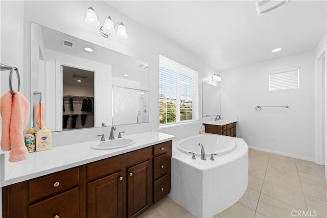 bathroom featuring independent shower and bath, tile patterned flooring, and vanity