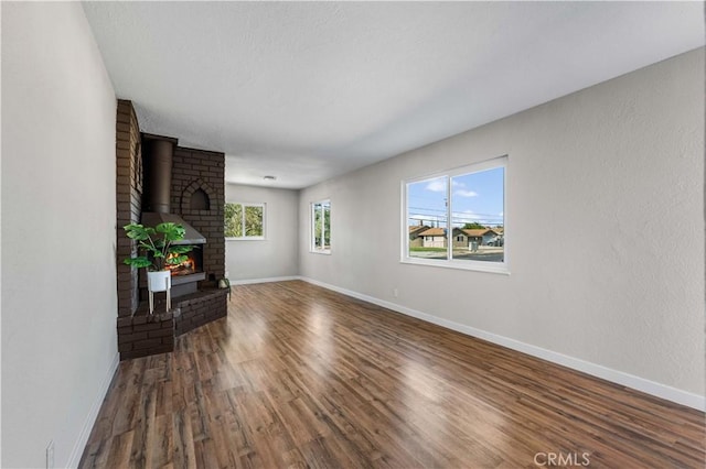 living room with dark hardwood / wood-style flooring and a wood stove