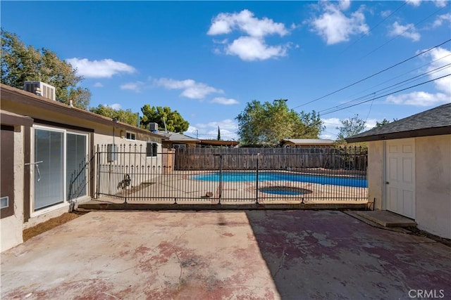 view of pool with central AC unit and a patio area