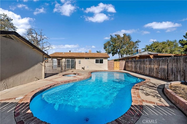 view of pool featuring a hot tub and a patio