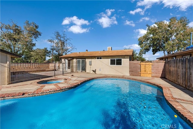 view of pool with an in ground hot tub and a patio